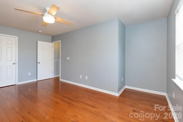 a view of a room with a ceiling fan