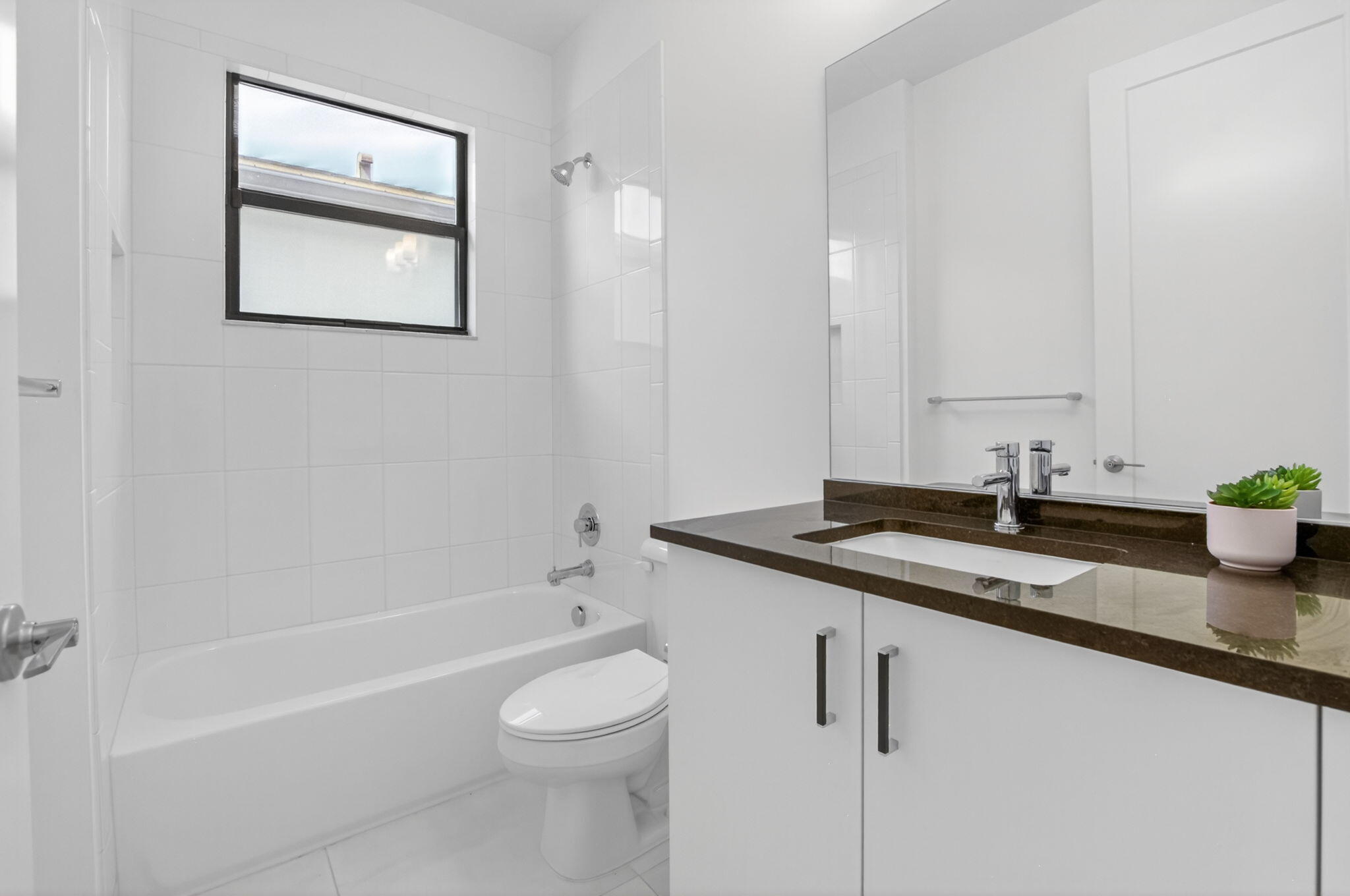 20278 Bandon Dunes Road Boca Raton, FL 33434 - Photo 55 of 113 a bathroom with a granite countertop sink a toilet and bathtub