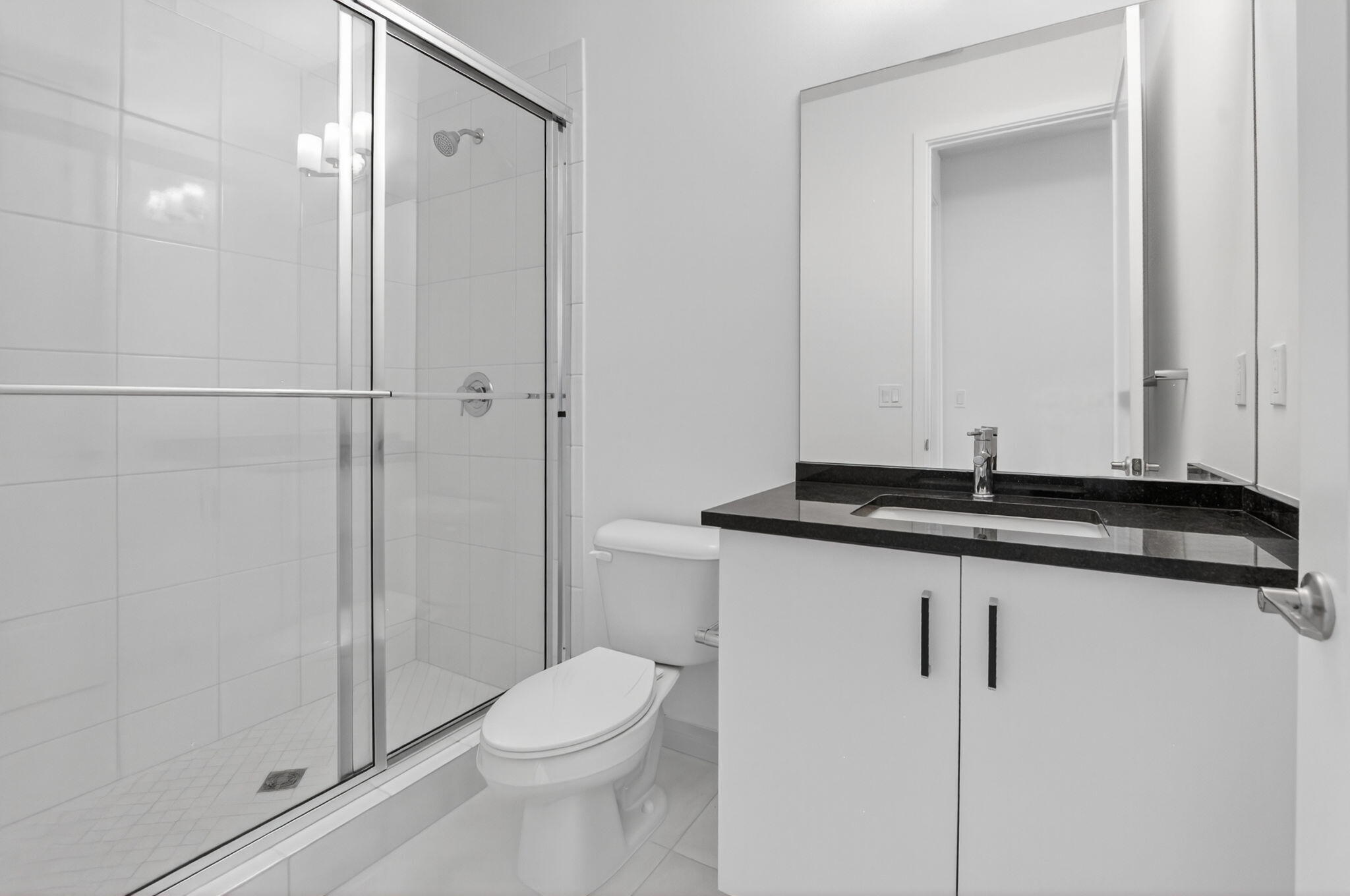 20278 Bandon Dunes Road Boca Raton, FL 33434 - Photo 60 of 113 a bathroom with a granite countertop sink a toilet and shower