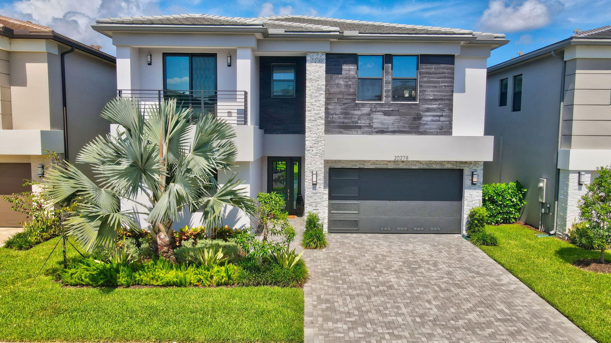 20278 Bandon Dunes Road Boca Raton, FL 33434 - Photo 70 of 113 a front view of a house with a garden