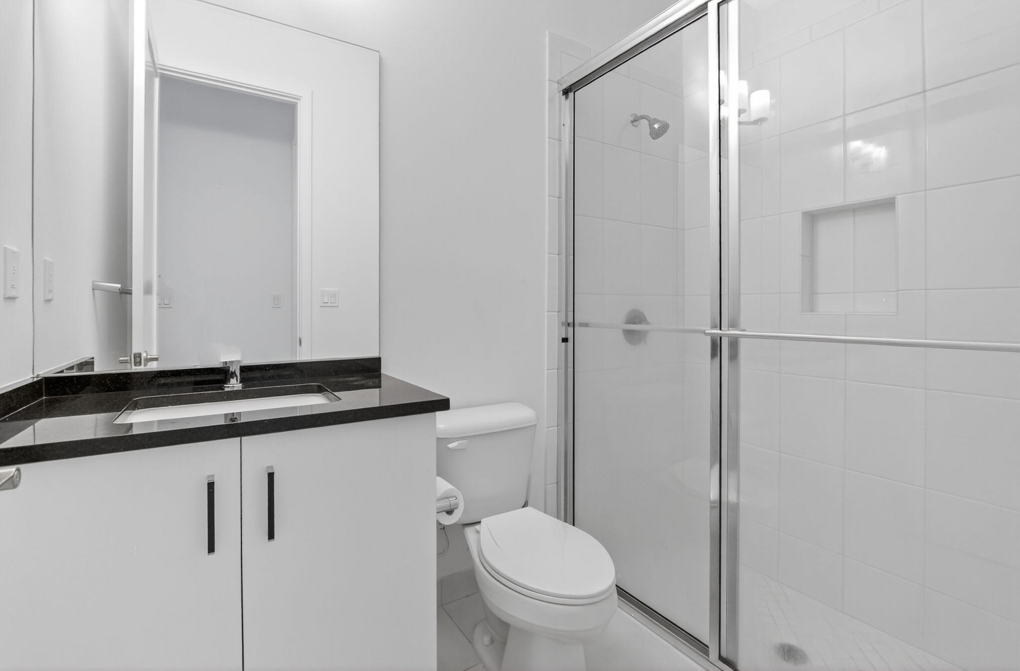 20278 Bandon Dunes Road Boca Raton, FL 33434 - Photo 9 of 113 a bathroom with a granite countertop sink toilet and shower