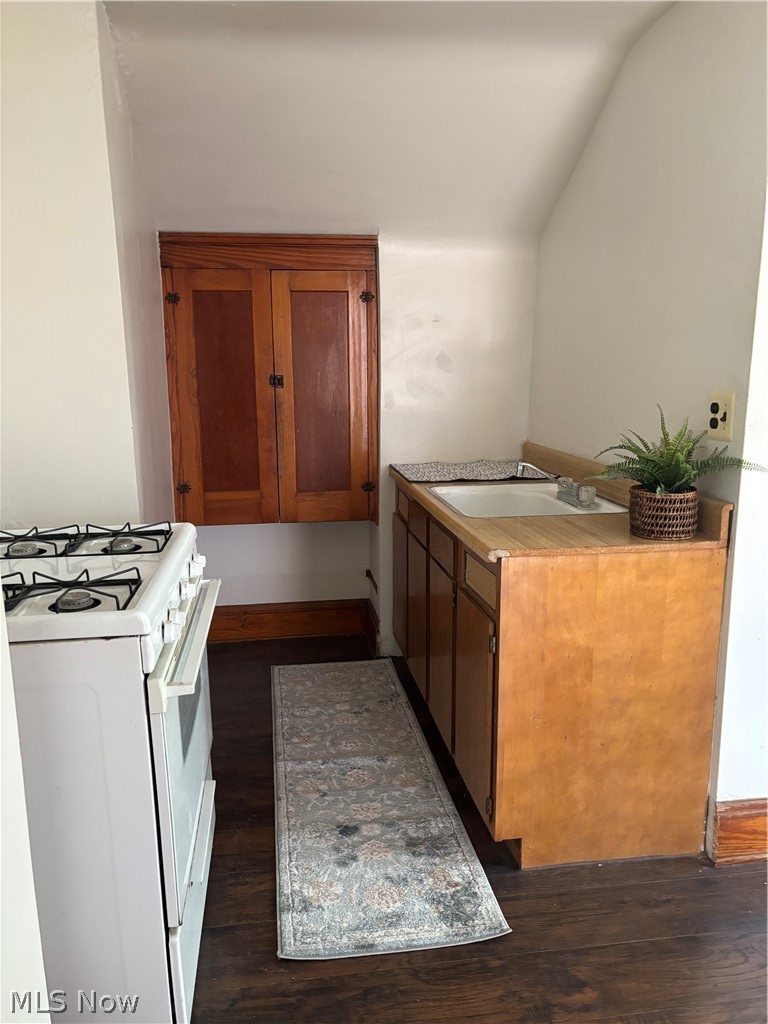 18309 Edgerton Road Cleveland, OH 44119 - Photo 11 of 19 Dark wood-finish flooring with light-toned cabinetry and a built-in sink