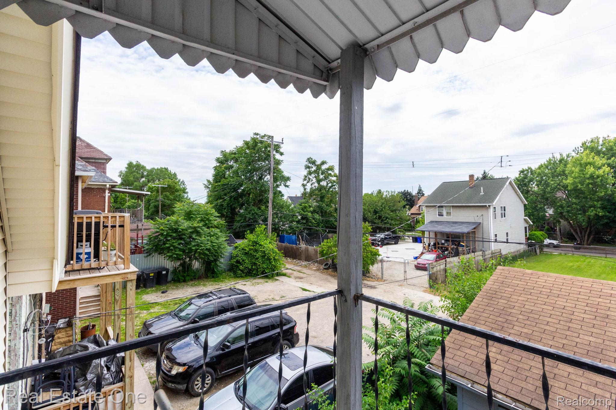 5485 Springwells Street Detroit, MI 48210 - Photo 36 of 47 Exterior balcony featuring a wrought iron railing and scalloped awning
