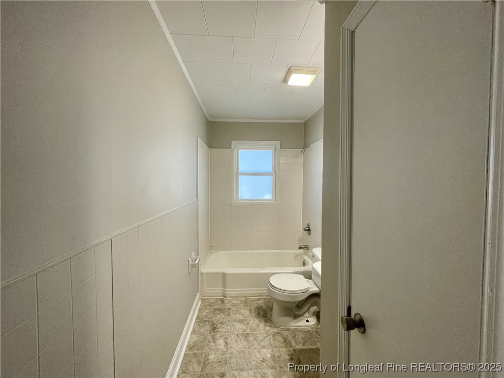 531 East Donaldson Avenue Raeford, NC 28376 - Photo 11 of 16 a bathroom with a granite countertop sink a toilet and shower