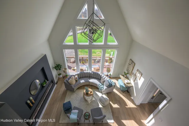 a living room with kitchen furniture and a wooden floor