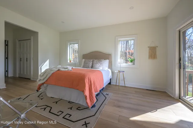 a balcony with wooden floor table and chairs
