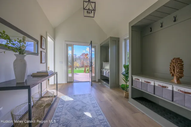 a view of a hallway to a livingroom with furniture