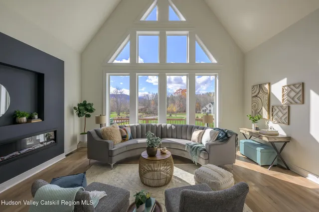 a living room with furniture and a potted plant