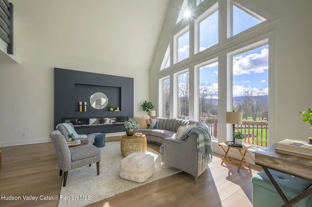 a view of a balcony with furniture and floor to ceiling window