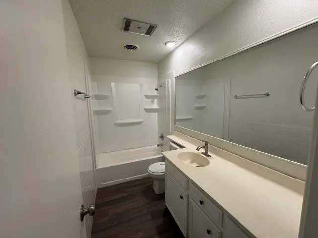 a bathroom with a double vanity sink toilet and shower