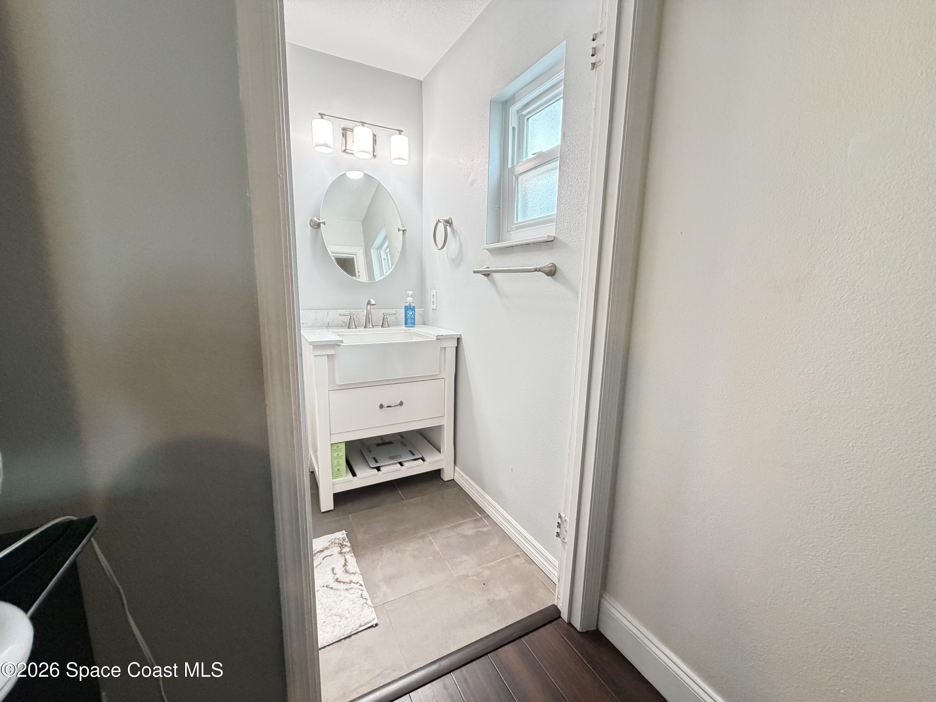 1578 West Powder Horn Road Titusville, FL 32796 - Photo 11 of 22 a room with a wooden door and mirror