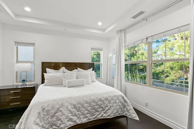 a bedroom with a bed and a large window