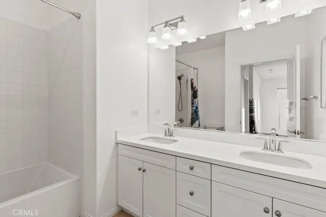 a bathroom with a double vanity sink mirror and double
