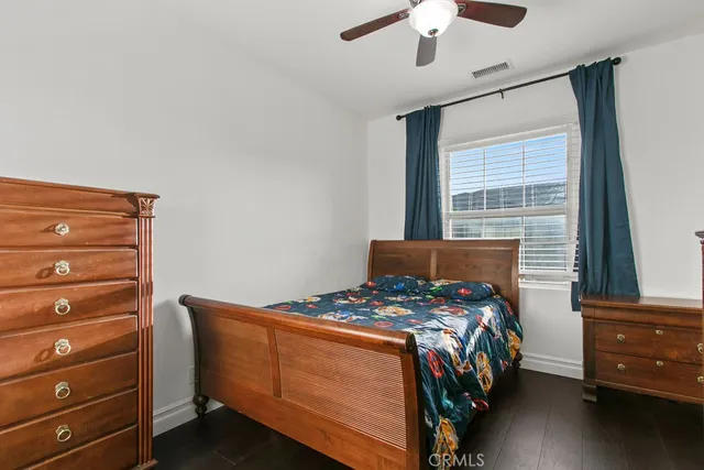 a bedroom with a bed and a dresser in it