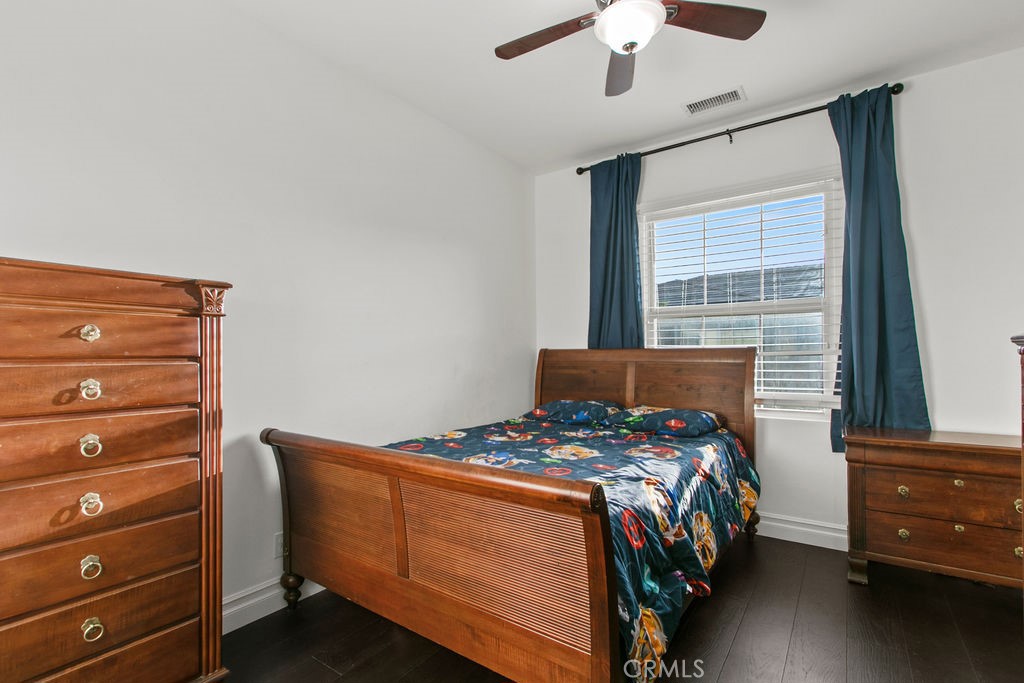 120 Gemstone Irvine, CA 92620 - Photo 22 of 43 a bedroom with a bed and a dresser in it