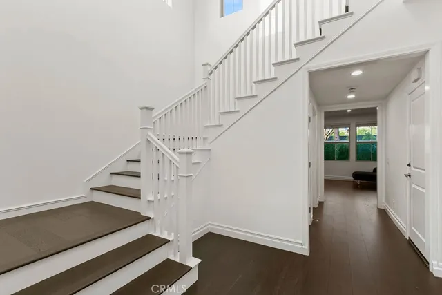 a view of entryway and hall with wooden floor