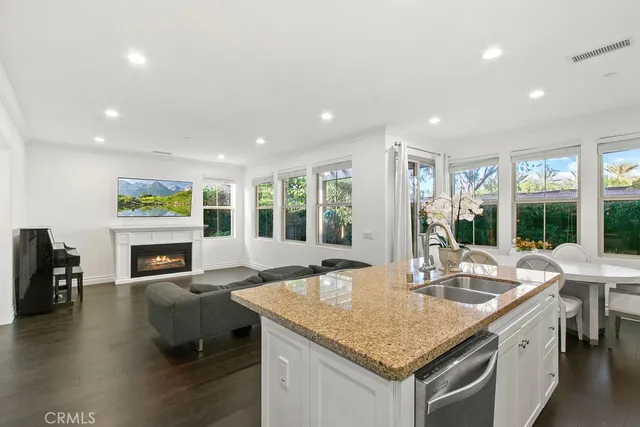 a kitchen with granite countertop a sink table and chairs