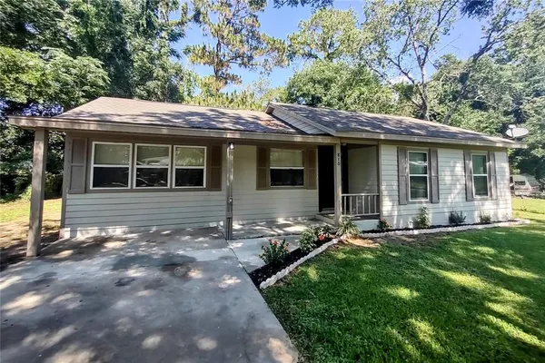 a backyard of a house with yard table and chairs