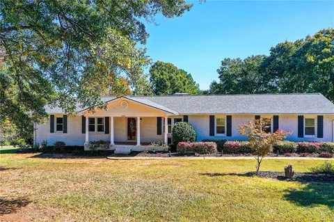 a front view of house with yard and outdoor seating