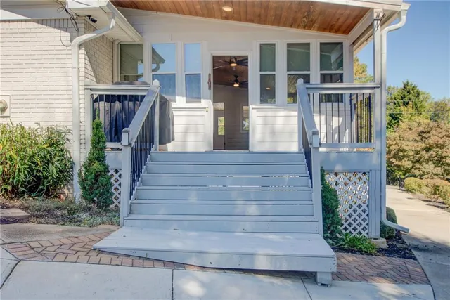 a view of empty room with wooden floor and fireplace