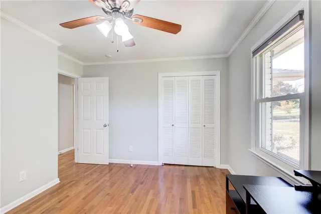a view of a livingroom with a fireplace wooden floor and window