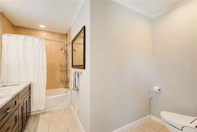 a large white kitchen with a fireplace and cabinets