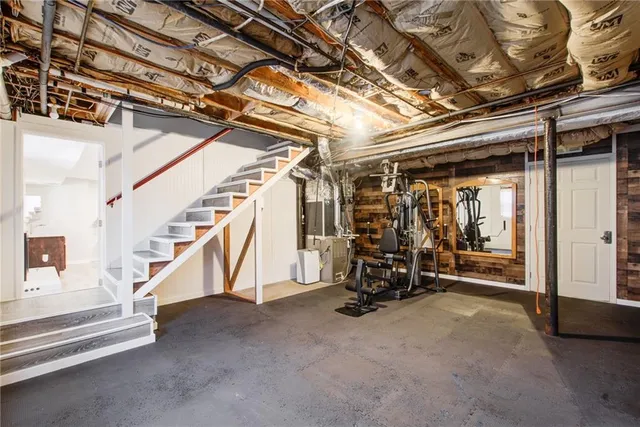 a bathroom with a toilet a sink a mirror and a window