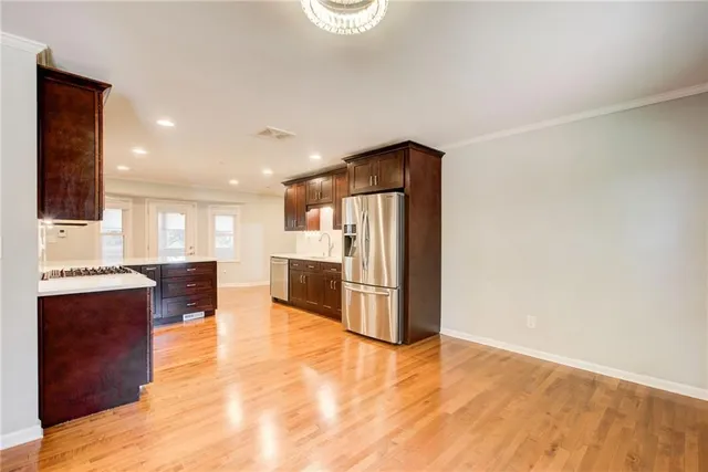 a kitchen with stainless steel appliances granite countertop a stove and a sink