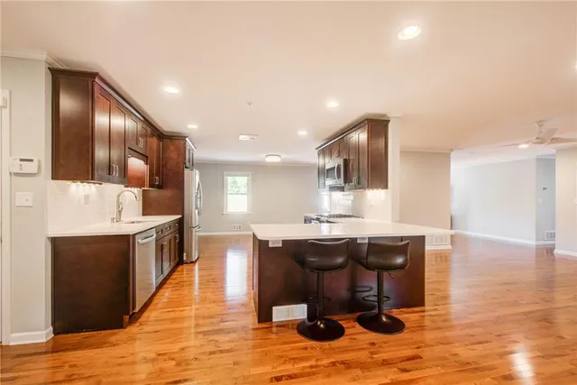 a kitchen with a refrigerator and a sink