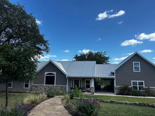 a front view of a house with a garden