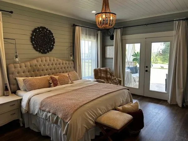 a bedroom with a large bed and a large window
