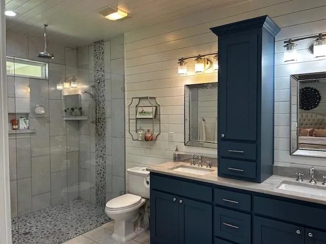 a bathroom with a toilet sink and shower