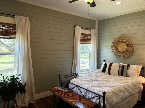 a bedroom with a bed and a chandelier
