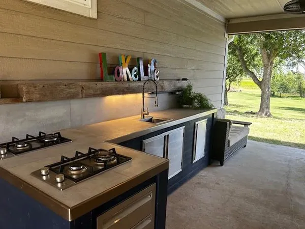 a kitchen with stainless steel appliances stove top oven and cabinets