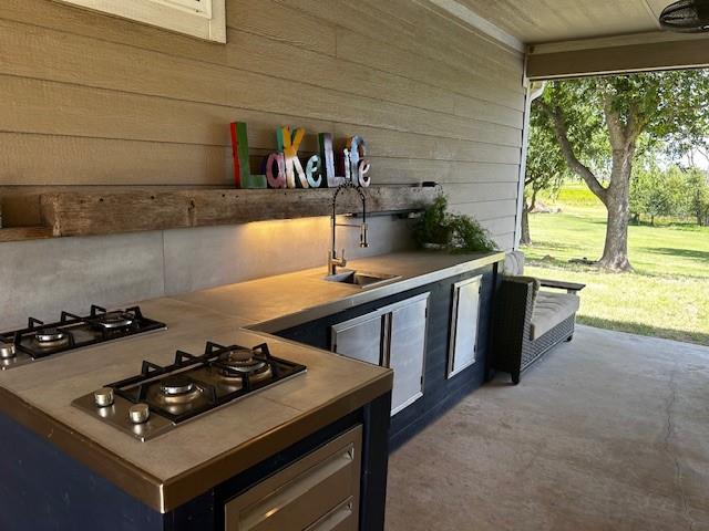 365 Mercers Preserve Road Comanche, TX 76442 - Photo 21 of 27 a kitchen with stainless steel appliances stove top oven and cabinets