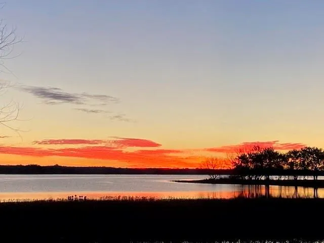a view of lake with sunset