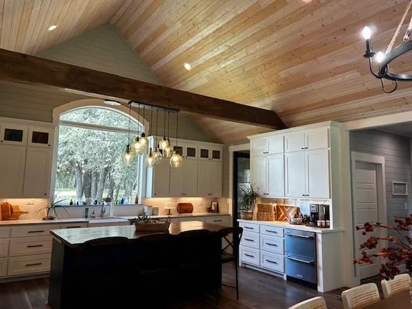 a kitchen with sink cabinets and wooden floor