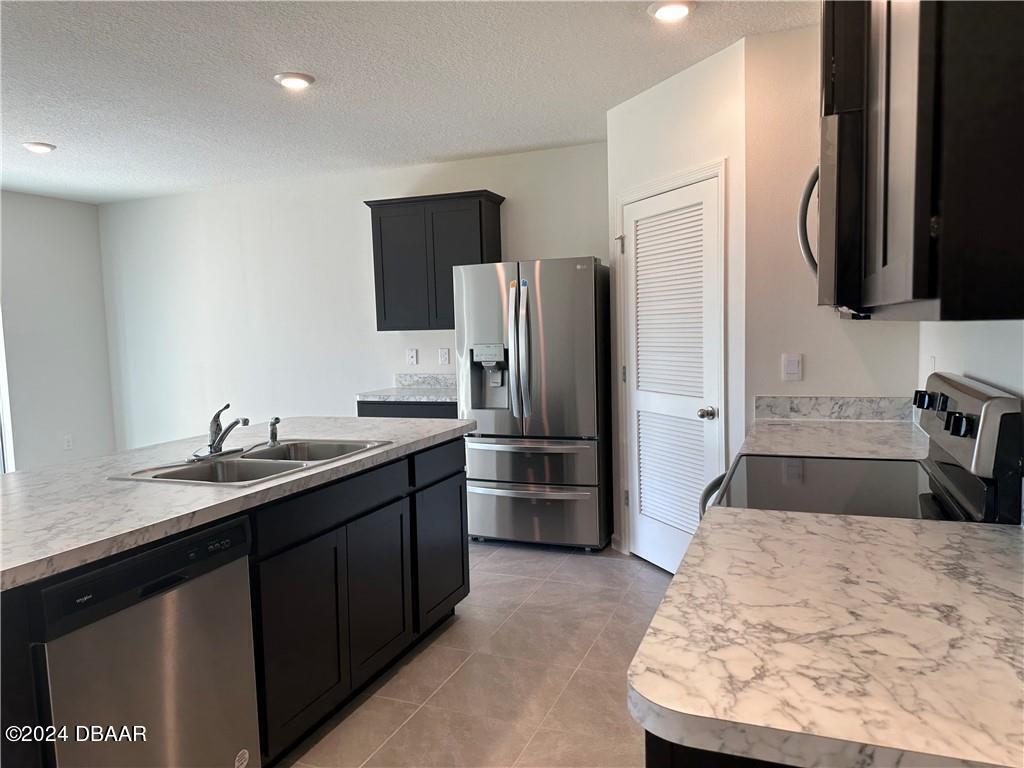 139 Empire Terrace Sebastian, FL 32958 - Photo 17 of 31 a kitchen with stainless steel appliances kitchen island granite countertop a refrigerator and a sink