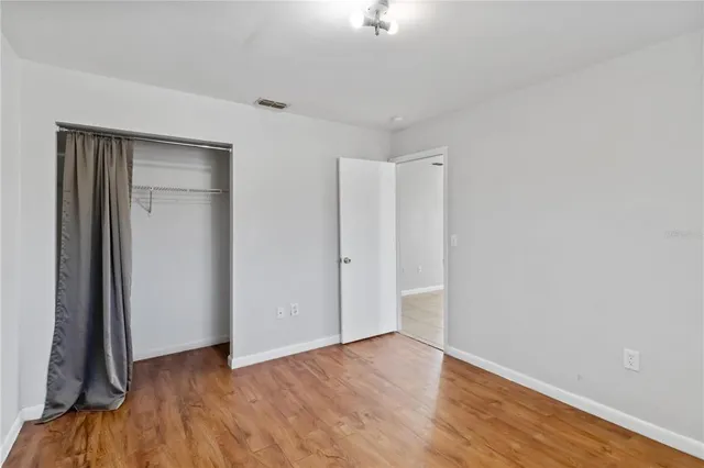 a view of a room with wooden floor and a window