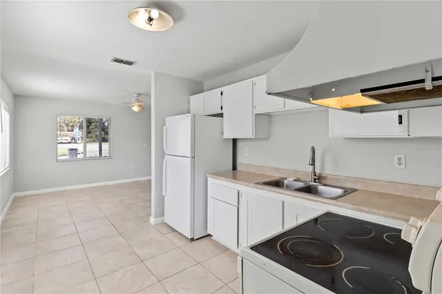 a kitchen with a sink stove and cabinets