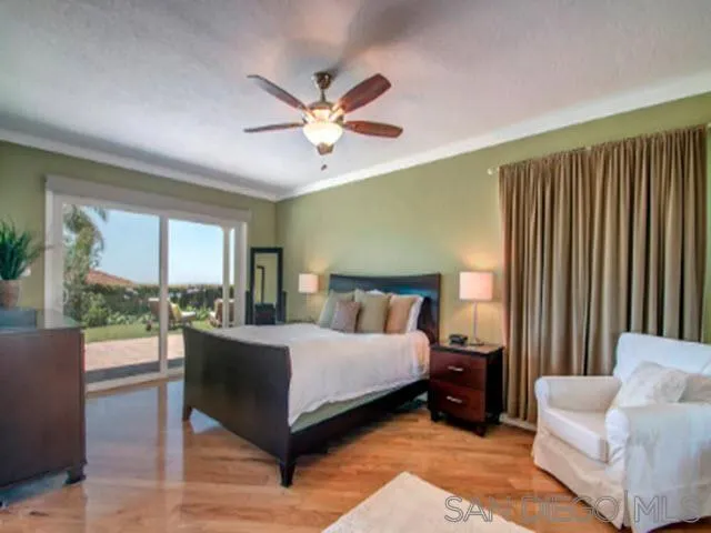 5512 Candlelight Drive La Jolla, CA 92037 - Photo 16 of 23 a living room with a bed furniture and a large window
