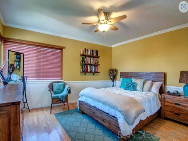 5512 Candlelight Drive La Jolla, CA 92037 - Photo 20 of 23 a bedroom with a bed and a chandelier