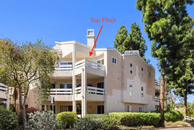 a front view of a multi story residential apartment building with a yard