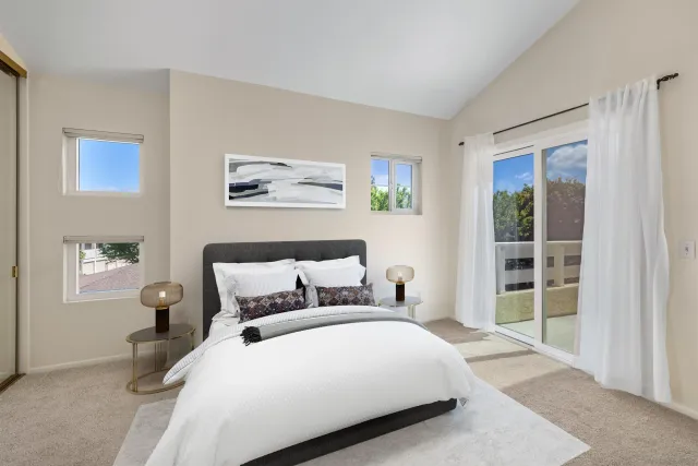 a bedroom with a large bed and a window