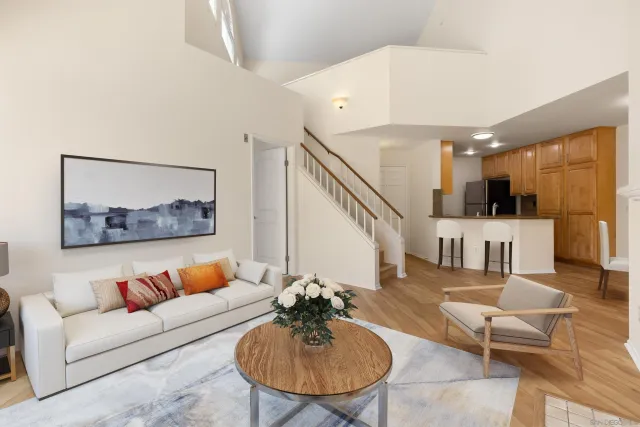 a living room with furniture and kitchen view