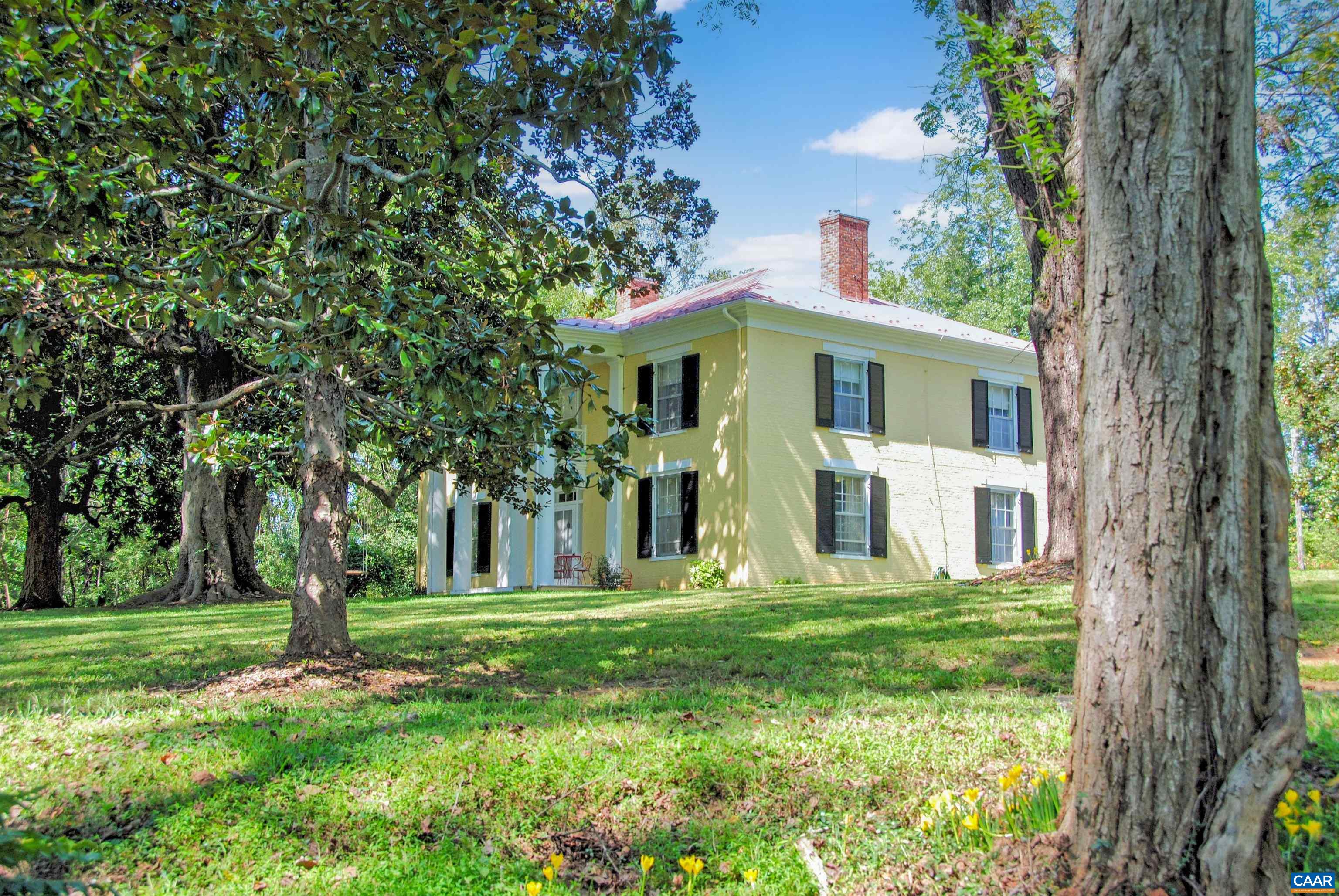 a front view of house with yard and green space