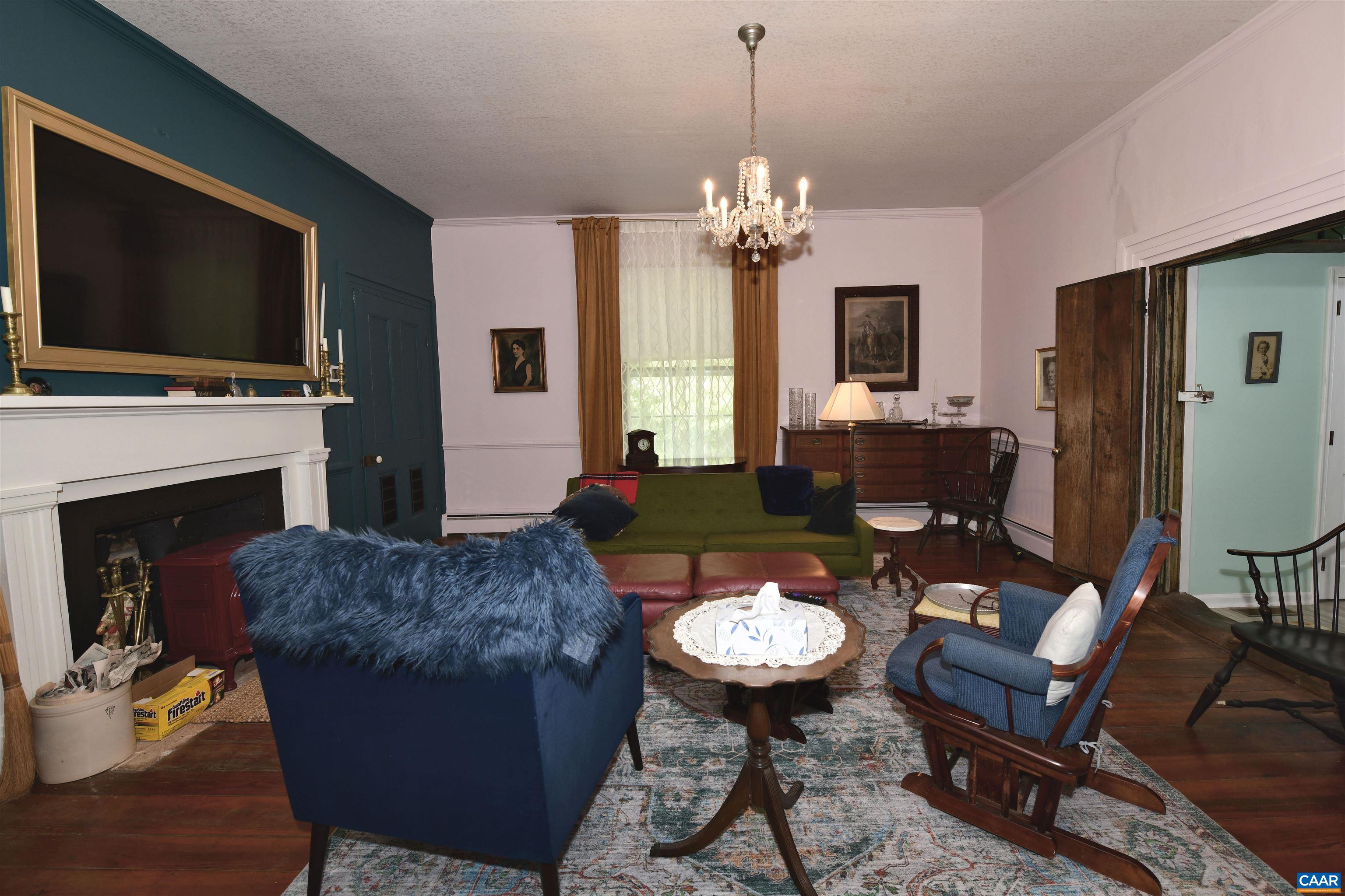 879 Evans Mill Road Dillwyn, VA 23936 - Photo 11 of 43 a living room with furniture a flat screen tv and a fireplace