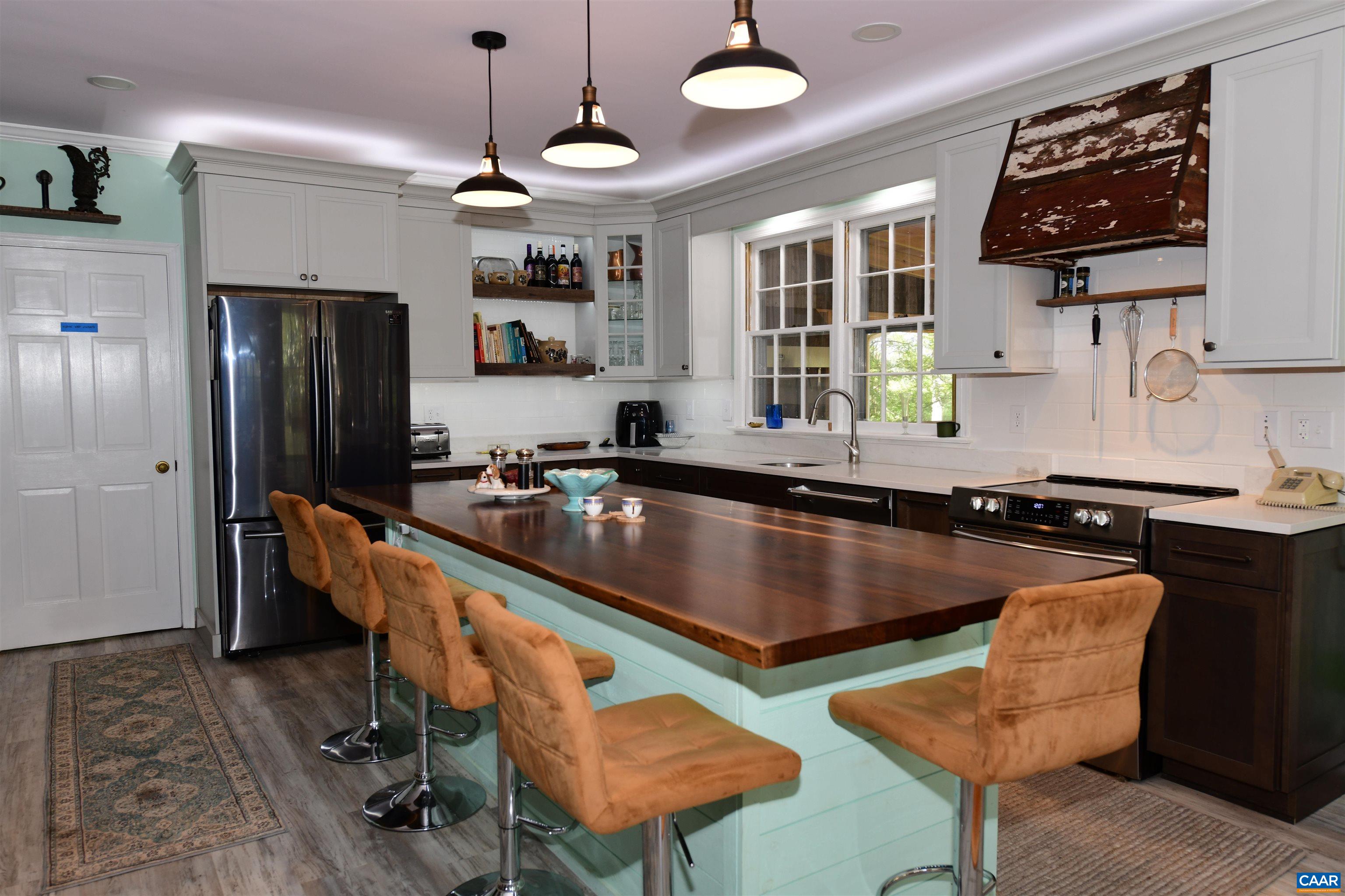 879 Evans Mill Road Dillwyn, VA 23936 - Photo 12 of 43 a kitchen with stainless steel appliances granite countertop a sink a stove and a refrigerator