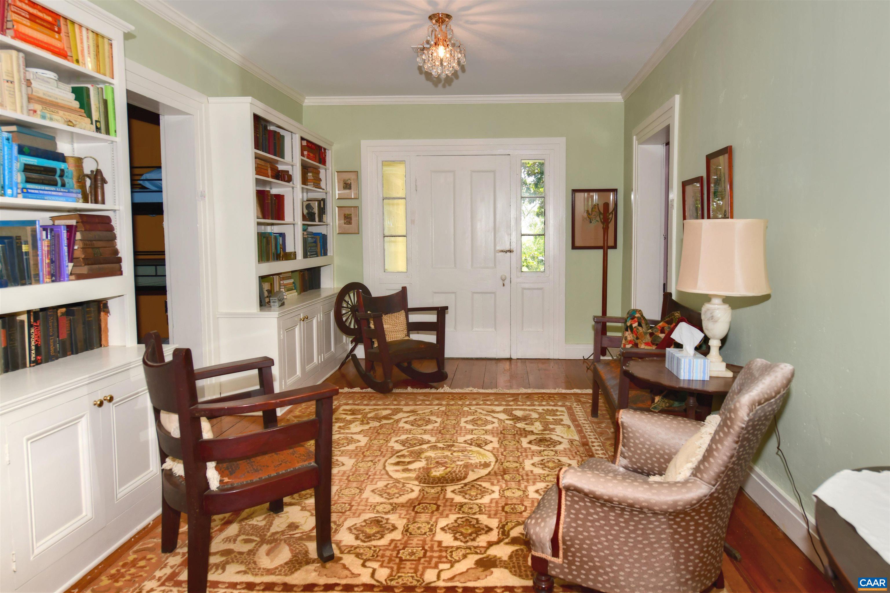 879 Evans Mill Road Dillwyn, VA 23936 - Photo 21 of 43 a living room with furniture a rug and a book shelf