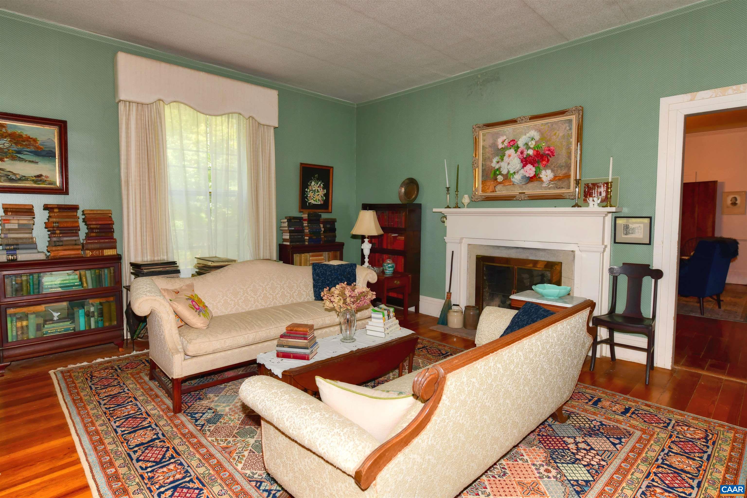 879 Evans Mill Road Dillwyn, VA 23936 - Photo 10 of 43 a living room with furniture large window and a fireplace